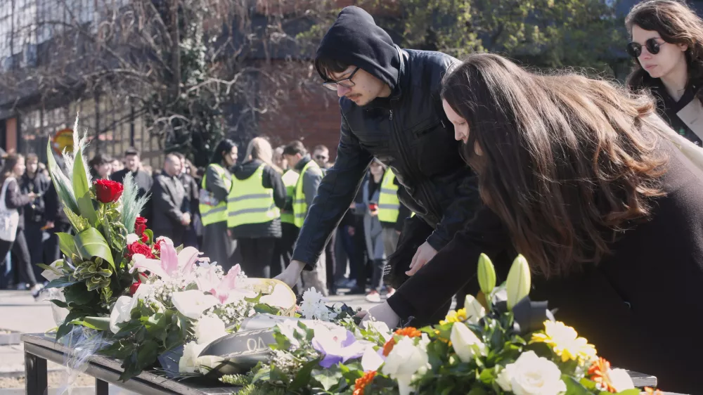 People lay flowers for the victims of a massive nightclub fire in the town of Kocani, in Skopje, North Macedonia, Tuesday, March 18, 2025. (AP Photo/Boris Grdanoski)