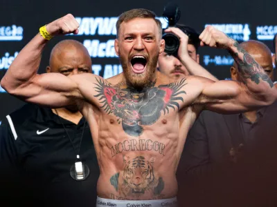 FILE PHOTO: UFC lightweight champion Conor McGregor of Ireland poses on the scale during his official weigh-in at T-Mobile Arena in Las Vegas, Nevada, U.S. on August 25, 2017.  REUTERS/Steve Marcus/File Photo
