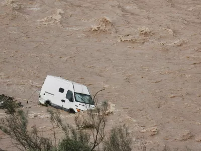 A van is photographed being swept away by the flood in Casasola, Malaga, Spain, Tuesday, March 18, 2025. (AP Photo/Gregorio Marrero)