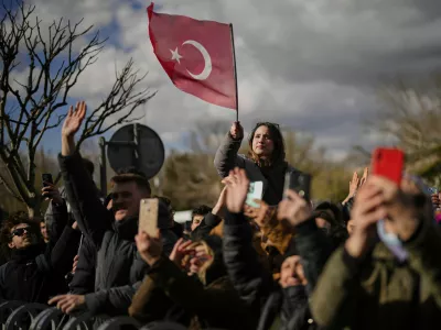 People gather outside the City Hall to protest the arrest of Istanbul Mayor Ekrem Imamoglu in Istanbul, Turkey, Wednesday, March 19, 2025. (AP Photo/Emrah Gurel)