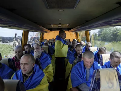 Ukrainian servicemen sit in a bus after returning from captivity during a POWs exchange in Sumy region, Ukraine, Friday, May 31, 2024. Ukraine returned 75 prisoners, including four civilians, in the latest exchange of POWs with Russia. It's the fourth prisoner swap this year, and 52nd since Russia invaded Ukraine. In all, 3 210 Ukrainian servicemen and civilians were returned since the outbreak of the war. (AP Photo/Evgeniy Maloletka)