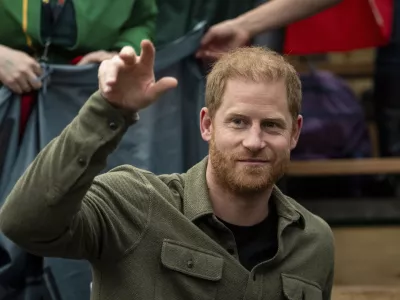 FILE - Prince Harry, the Duke of Sussex, cheers with Team Lithuania during Sitting Volleyball at the 2025 Invictus Games, in Vancouver, on Saturday, Feb. 15, 2025. (Ethan Cairns/The Canadian Press via AP, file)