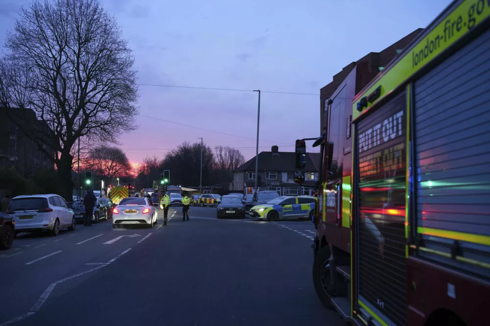 Emergency services are seen at the scene in Roseville Road, leading to Heathrow Airport, west London, Friday, March 21, 2025, near the North Hyde electrical substation, which caught fire Thursday night. (James Weech/PA via AP)