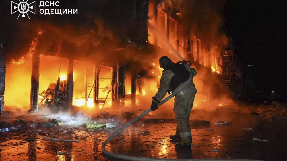 In this photo provided by the Ukrainian Emergency Service, firefighters put out the fire at a storehouse following a Russian attack in Odesa, Ukraine, Friday, March 21, 2025. (Ukrainian Emergency Service via AP)