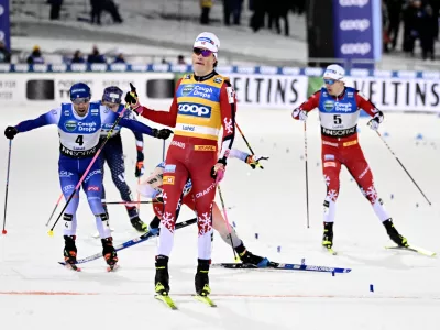 Winner Johannes Hoesflot Klaebo of Norway, Frederico Pellegrino of Italy, left, and Erik Valnes of Norway, right, compete during the men's cross-country skiing freestyle sprint final at the FIS Nordic World Cup Lahti Ski Games in Lahti, Finland, Friday, March 21, 2025. (Emmi Korhonen/Lehtikuva via AP)