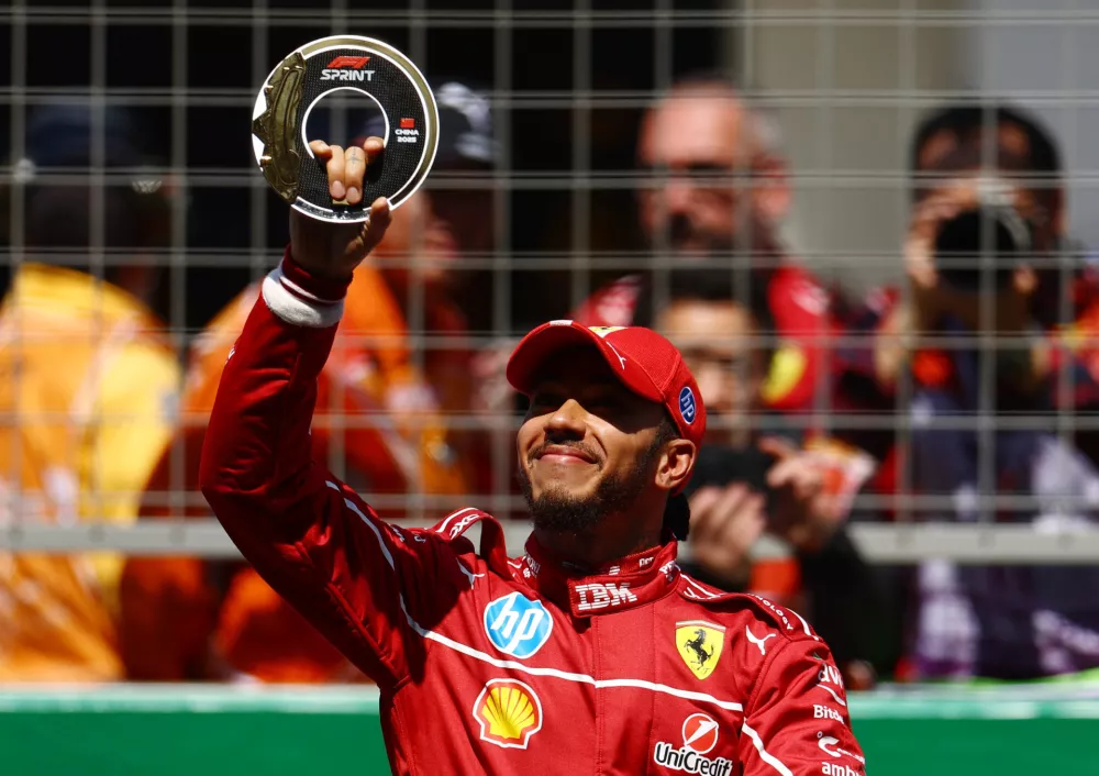 Formula One F1 - Chinese Grand Prix - Shanghai International Circuit, Shanghai, China - March 22, 2025 Ferrari's Lewis Hamilton poses with his trophy after winning the sprint race REUTERS/Edgar Su