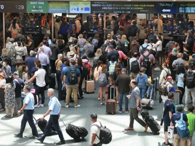 FILE - Travelers wait in line for security in the east hall atrium at Orlando International Airport, Thursday, May 25, 2023 in Orlando, Fla. (Joe Burbank /Orlando Sentinel via AP, File)