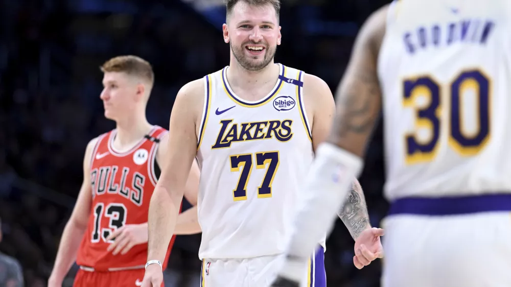 Los Angeles Lakers guard Luka Doncic (77) smiles after making a basket against the Chicago Bulls of an NBA basketball game Saturday, March 22, 2025, in Los Angeles. (AP Photo/Wally Skalij)