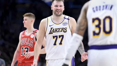 Los Angeles Lakers guard Luka Doncic (77) smiles after making a basket against the Chicago Bulls of an NBA basketball game Saturday, March 22, 2025, in Los Angeles. (AP Photo/Wally Skalij)