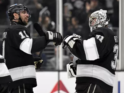Los Angeles Kings center Anze Kopitar (11) celebrates with goaltender David Rittich (31) after they defeated the Carolina Hurricanes in an NHL hockey game in Los Angeles, Saturday, March 22, 2025. (AP Photo/Alex Gallardo)