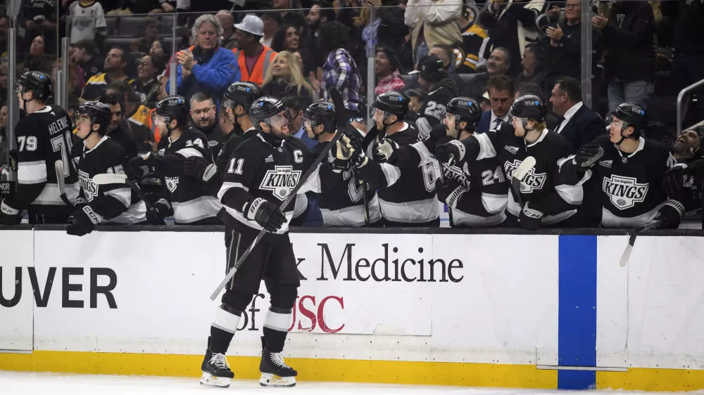 Los Angeles Kings center Anze Kopitar (11) celebrates after his goal during the first period of an NHL hockey game against the Boston Bruins, Sunday, March 23, 2025, in Los Angeles. (AP Photo/William Liang)