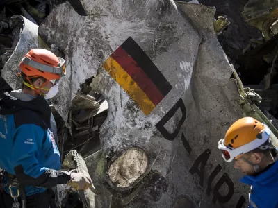 FILE - In this photo taken on March 31, 2015 and provided by the French Interior Ministry, French emergency rescue services work among the debris of the Germanwings passenger jet at the crash site near Seyne-les-Alpes, France. (Yves Malenfer/Ministere de l'Interieur, File)