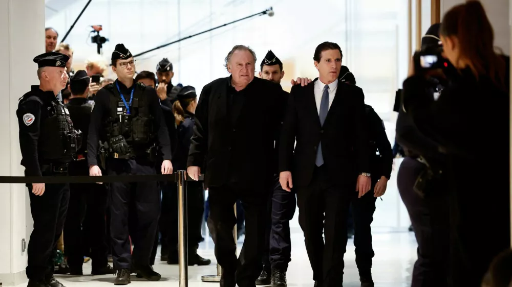 French actor Gerard Depardieu walks with his lawyer Jeremie Assous, on the day of Depardieu's trial for two sexual assaults allegedly committed on the set of the film "Les Volets Verts", at the courthouse in Paris, France, March 24, 2025. REUTERS/Benoit Tessier