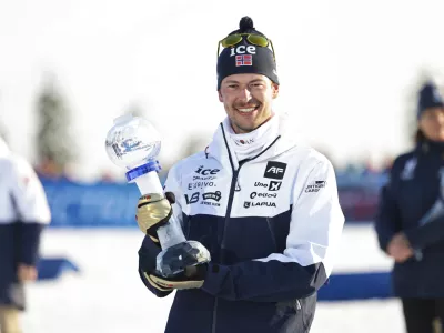 Sturla Holm L&aelig;greid of Norway wins the overall World Cup after the biathlon men's 15 km mass start at the World Cup in Holmenkollen, Norway, Sunday, March 23, 2025. (Thomas Andersen/NTB Scanpix via AP)