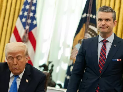 U.S. Defense Secretary Pete Hegseth stands by U.S. President Donald Trump, in the Oval Office at the White House, in Washington, D.C., U.S., March 21, 2025. REUTERS/Carlos Barria