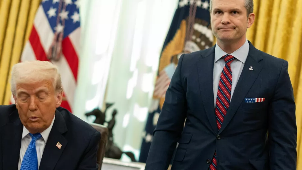 U.S. Defense Secretary Pete Hegseth stands by U.S. President Donald Trump, in the Oval Office at the White House, in Washington, D.C., U.S., March 21, 2025. REUTERS/Carlos Barria