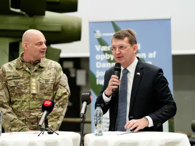 Denmark's Defense Minister Troels Lund Poulsen, right, and Chief of Defense Michael Hyldgaard attend a press conference on a ground-based air defense system, in Gadstrup, Denmark Wednesday, March 26, 2025. (Mads Claus Rasmussen/Ritzau Scanpix via AP)