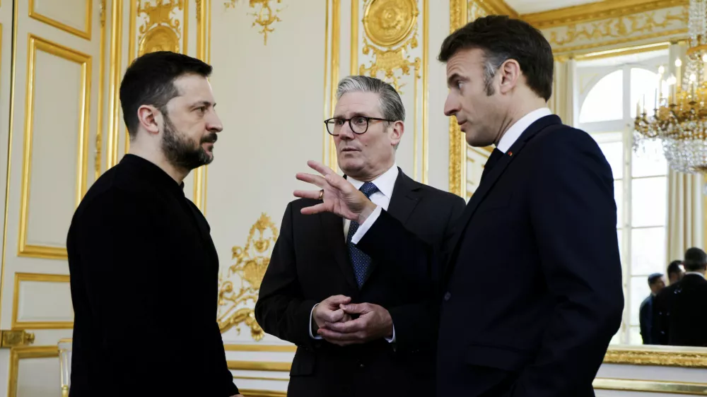 Ukraine's President Volodymyr Zelenskyy, left, French President Emmanuel Macron, right, and Britain's Prime Minister Keir Starmer speak during a trilateral meeting on the sidelines of a summit for "coalition of the willing" at the Elysee Palace, Thursday, March 27, 2025. (Ludovic Marin, Pool via AP)