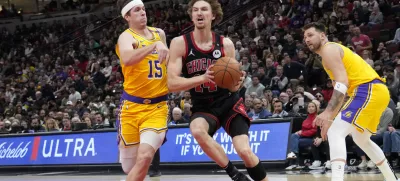 Mar 27, 2025; Chicago, Illinois, USA; Los Angeles Lakers guard Austin Reaves (15) defends Chicago Bulls forward Matas Buzelis (14) during the first quarter at United Center. Mandatory Credit: David Banks-Imagn Images