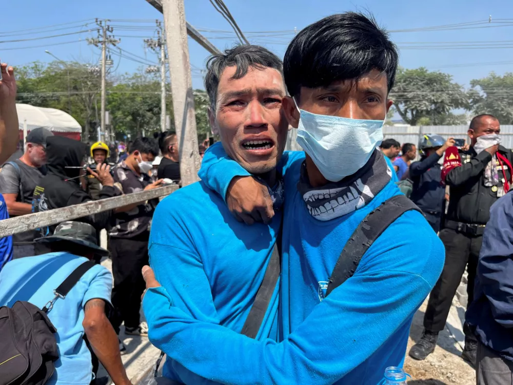 Workers react near a site of a collapsed building after the tremors of a strong earthquake that struck central Myanmar on Friday affected Bangkok, Thailand, March 28, 2025. REUTERS/Ann Wang