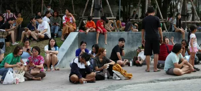 People sit on the pavement after a strong earthquake struck central Myanmar on Friday, earthquake monitoring services said, which affected Bangkok as well with hundreds of people pouring out of buildings in the Thai capital in panic after the tremors, in Bangkok, Thailand, March 28, 2025. REUTERS/Chalinee Thirasupa
