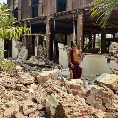 A Buddhist monk walks near a damaged building at a monastery compound after an earthquake, Friday, March 28, 2025 in Naypyitaw, Myanmar. (AP Photo/Aung Shine Oo)