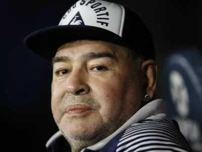 FILE - In this March 7, 2020 file photo, Diego Maradona, coach of Gimnasia y Esgrima, sits on the bench prior to Argentina's soccer league match against Boca Juniors at La Bombonera stadium in Buenos Aires, Argentina. Maradona turns 60 on Friday, Oct. 30, 2020. (AP Photo/Natacha Pisarenko, File)