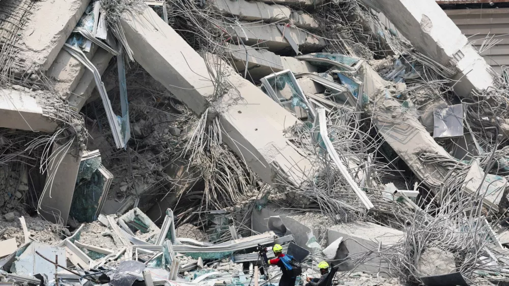 Rescue personnel work at the site of a building that collapsed, following a strong earthquake, in Bangkok, Thailand, March 29, 2025. REUTERS/Chalinee Thirasupa