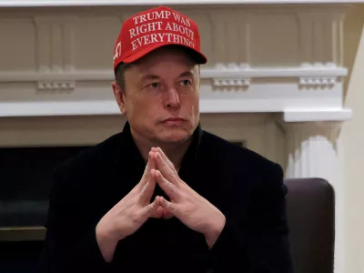 FILE PHOTO: Tesla CEO Elon Musk wears a 'Trump Was Right About Everything!' hat while attending a cabinet meeting at the White House, in Washington, D.C., U.S., March 24, 2025. REUTERS/Carlos Barria/File Photo