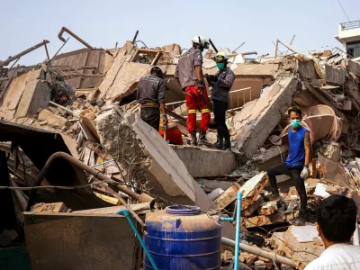Rescuers work at the site of a building that collapsed, in the aftermath of a strong earthquake, in Mandalay, Myanmar, March 30, 2025. REUTERS/Stringer