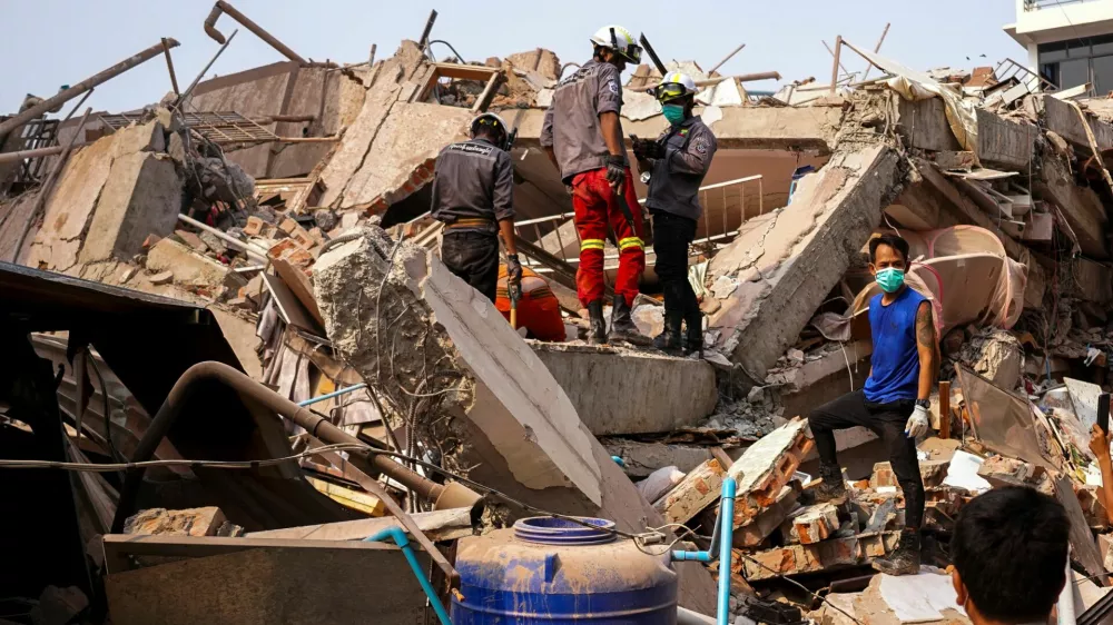 Rescuers work at the site of a building that collapsed, in the aftermath of a strong earthquake, in Mandalay, Myanmar, March 30, 2025. REUTERS/Stringer