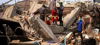 Rescuers work at the site of a building that collapsed, in the aftermath of a strong earthquake, in Mandalay, Myanmar, March 30, 2025. REUTERS/Stringer