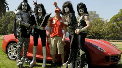 Defending world drivers champion Ferrari's Kimi Raikkonen of Finland, center, stands with U.S. rock group Kiss at the Albert Park circuit in Melbourne, Australia, Wednesday, March 12, 2008. The season's opening Formula One race will be held here on Sunday March 16. Members of the band are, from left, Gene Simmons, Tommy Thayer, Paul Stanley and Eric Singer. (AP Photo/Ercole Colombo)