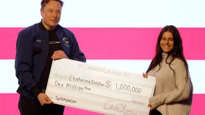 Elon Musk presents a check for  million dollars during a town hall Sunday, March 30, 2025, in Green Bay, Wis. (AP Photo/Jeffrey Phelps)