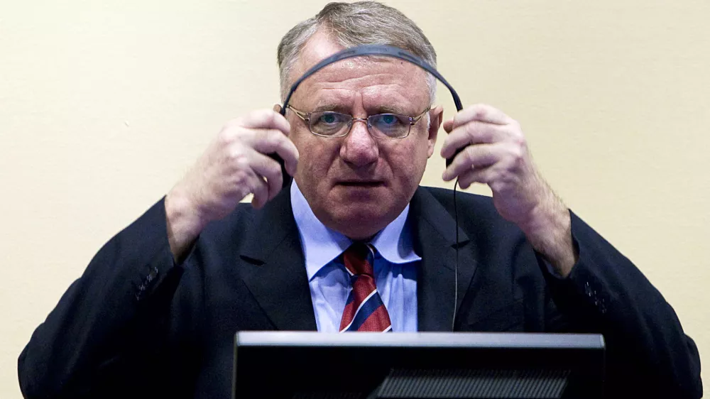FILE - In this March 6, 2009 file photo Serbian ultranationalist leader Vojislav Seselj seen in court at the International Criminal Tribunal for the former Yugoslavia (ICTY) in The Hague, Netherlands. Seselj, 58, is to start making his closing arguments on Wednesday, March 14, 2012. Seselj has been charged with crimes against Muslims and Croats, allegedly committed by the volunteers recruited by his party during 1991-1995 war that followed the breakup of the former Yugoslavia. (AP Photo/Valerie Kuypers, Pool, File)