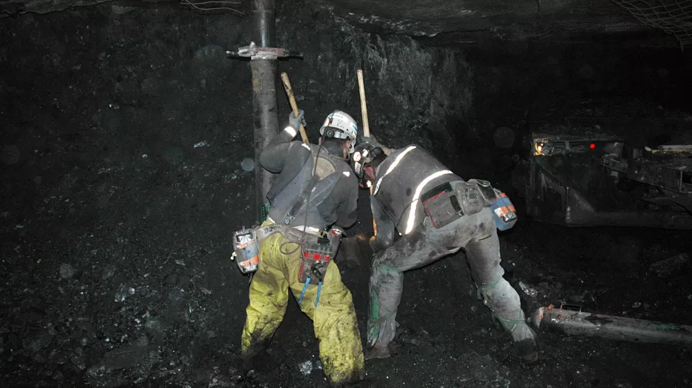 ** CORRECTS WORDING TO REFLECT THAT WORKERS ARE IN THE MINE PASSAGEWAY, NOT MAIN PASSAGEWAY ** In this photo released by Utah American Energy Inc., unidentified miners clear the mine passageway of the Crandall Canyon Mine in an effort to reach six trapped miners inside the mine, northwest of Huntington, Utah, Tuesday, Aug. 14, 2007. Crews are drilling a third hole in the more than weeklong search for six missing coal miners, and may drill a fourth if this attempt turns up nothing. (AP Photo/Utah America Energy Inc.)  **NO SALES**