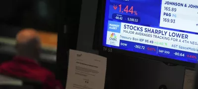 People work on the floor at the New York Stock Exchange in New York, Monday, March 31, 2025. (AP Photo/Seth Wenig)