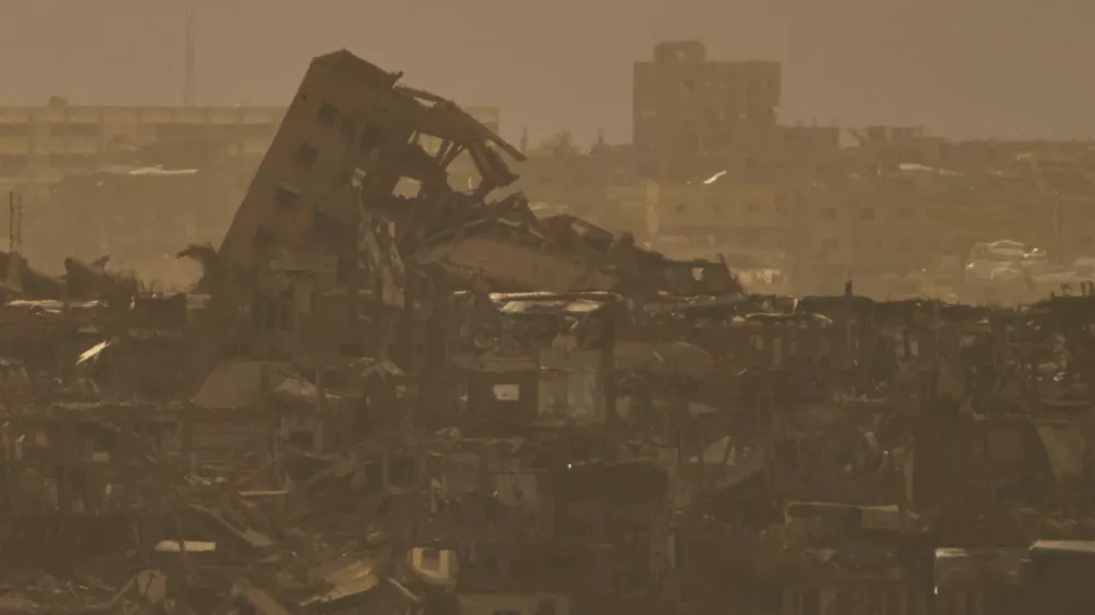 Buildings that were destroyed during the Israeli ground and air operations stand in northern of Gaza Strip as seen from southern Israel, Tuesday, April 1, 2025. (AP Photo/Leo Correa)