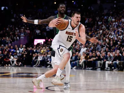 Apr 1, 2025; Denver, Colorado, USA; Denver Nuggets center Nikola Jokic (15) drives to the basket against Minnesota Timberwolves forward Julius Randle (30) in the fourth quarter at Ball Arena. Mandatory Credit: Isaiah J. Downing-Imagn Images