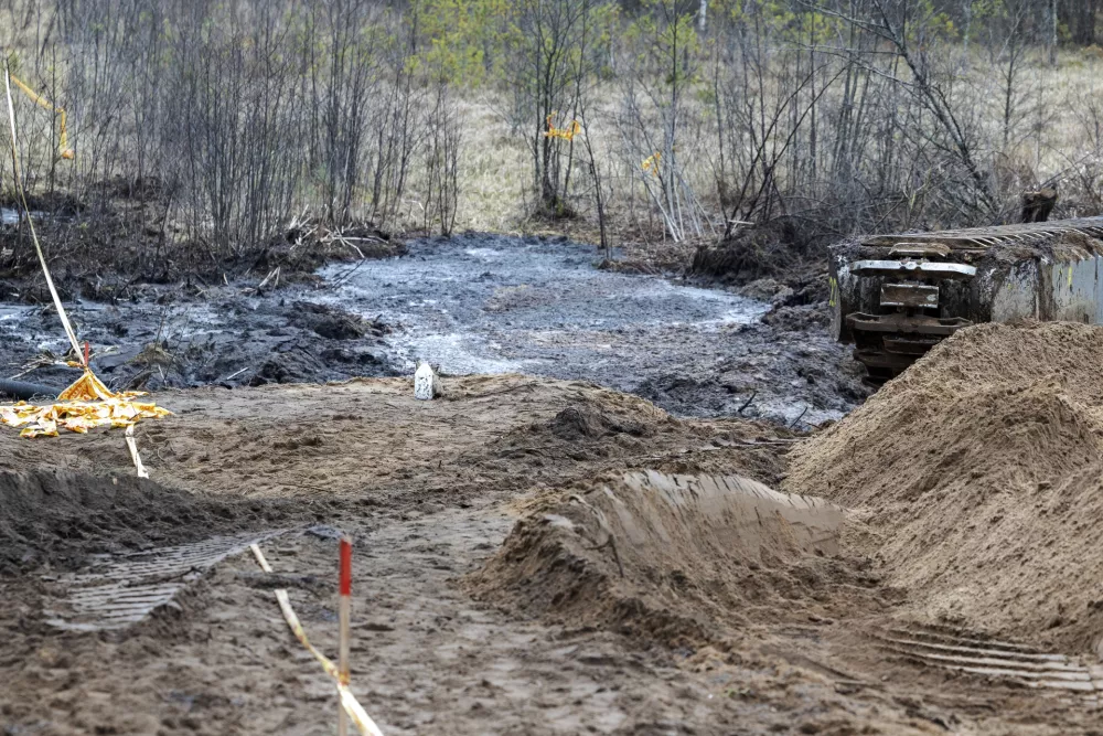 Recovery efforts continue for four missing U.S. soldiers near the spot where their Hercules armored vehicle was found submerged at a training range in Pabrade, north of the capital Vilnius, Lithuania on Thursday, March 27, 2025. (AP Photo/Mindaugas Kulbis)