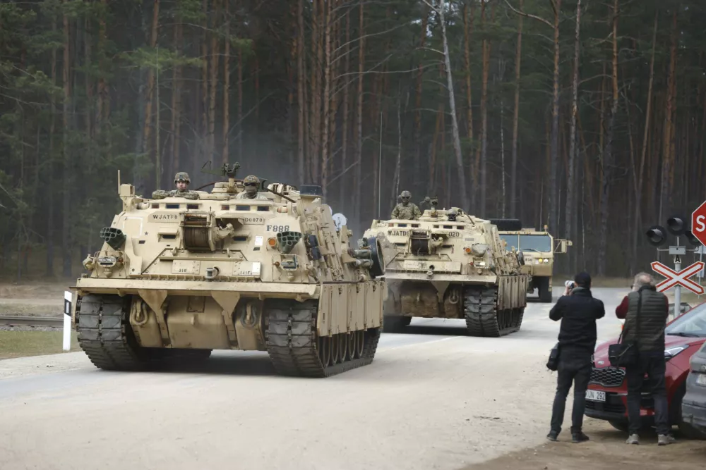 U.S. Army military vehicles including two M88 Recovery vehicles roll to attend recovery efforts continue for a missed U.S. Army soldier, as three other found dead on Monday, at a training range in Pabrade, north of Vilnius, Lithuania, Tuesday, April 1, 2025. (AP Photo/Mindaugas Kulbis)