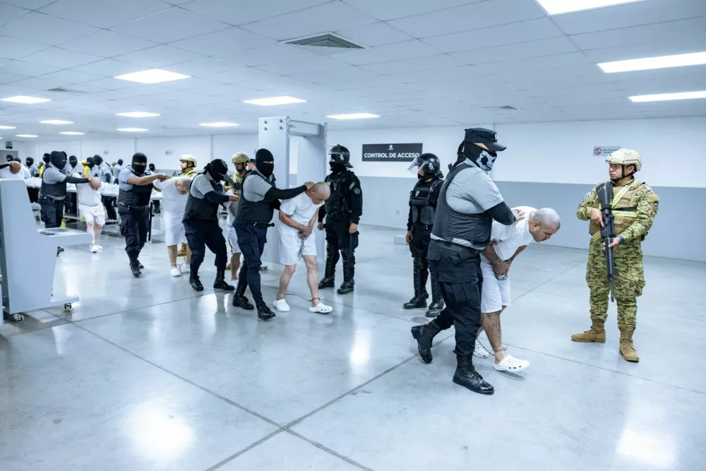 Salvadoran prison guards escort alleged members of the Venezuelan gang Tren de Aragua and the MS-13 gang recently deported by the U.S. government to be imprisoned in the Terrorism Confinement Center (CECOT) prison, as part of an agreement with the Salvadoran government, in Tecoluca, El Salvador, in this handout image obtained March 31, 2025. Secretaria de Prensa de la Presidencia/Handout via REUTERS ATTENTION EDITORS - THIS IMAGE HAS BEEN SUPPLIED BY A THIRD PARTY. NO RESALES. NO ARCHIVES
