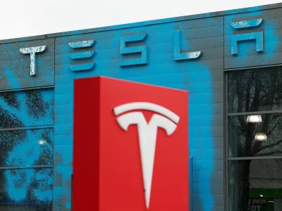 Blue paint covers the facade of a Tesla dealership after it was sprayed by supporters of New Generation (Neue Generation) during a protest against Elon Musk and against what organisers say is the destruction of democracy and the climate by the rich, in Berlin, Germany, March 31, 2025. REUTERS/Christian Mang   TPX IMAGES OF THE DAY