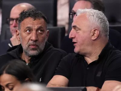 Former Los Angeles Laker Vlade Divac, left, sits with Sasa Doncic, father of Los Angeles Lakers' Luka Doncic, during the second half of an NBA basketball game between the Lakers and the Golden State Warriors Thursday, April 3, 2025, in Los Angeles. (AP Photo/Mark J. Terrill)