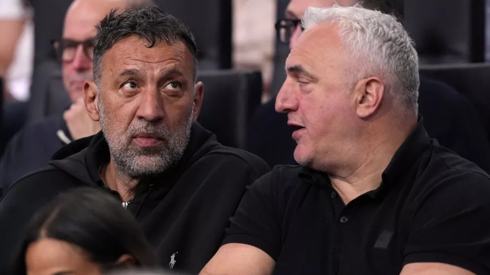 Former Los Angeles Laker Vlade Divac, left, sits with Sasa Doncic, father of Los Angeles Lakers' Luka Doncic, during the second half of an NBA basketball game between the Lakers and the Golden State Warriors Thursday, April 3, 2025, in Los Angeles. (AP Photo/Mark J. Terrill)