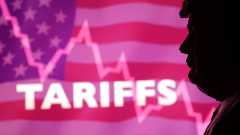 A 3D printed miniature model of U.S. President Donald Trump, U.S. flag, decreasing stock graph and word "Tariffs" are seen in this illustration taken, April 4, 2025. REUTERS/Dado Ruvic/Illustration