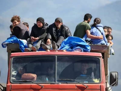 FILE PHOTO: Refugees from Nagorno-Karabakh region ride in a truck upon their arrival at the border village of Kornidzor, Armenia, September 27, 2023. REUTERS/Irakli Gedenidze   TPX IMAGES OF THE DAY/File Photo