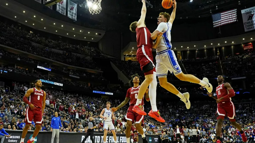 Mar 29, 2025; Newark, NJ, USA; Duke Blue Devils forward Cooper Flagg (2) goes up to dunk the ball against Alabama Crimson Tide forward Grant Nelson (4) during the second half in the East Regional final of the 2025 NCAA tournament at Prudential Center. Mandatory Credit: Robert Deutsch-Imagn Images
