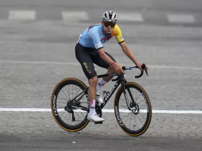FILE -Remco Evenepoel, of Belgium, celebrates winning the men's road cycling event, at the 2024 Summer Olympics, Saturday, Aug. 3, 2024, in Paris, France. (AP Photo/Dar Yasin, File)