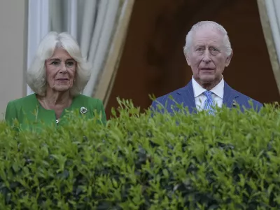 King Charles III, right, and Queen Camilla listen to the band of the Welsh Guards as they arrive at the Residence of the British Ambassador to Italy Villa Wolkonsky in Rome, Tuesday, April 8, 2025 to meet with memebers of the British community in Italy. (AP Photo/Andrew Medichini)